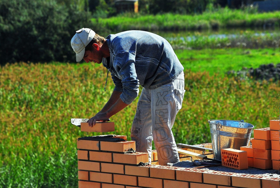 Mason plastering a wall